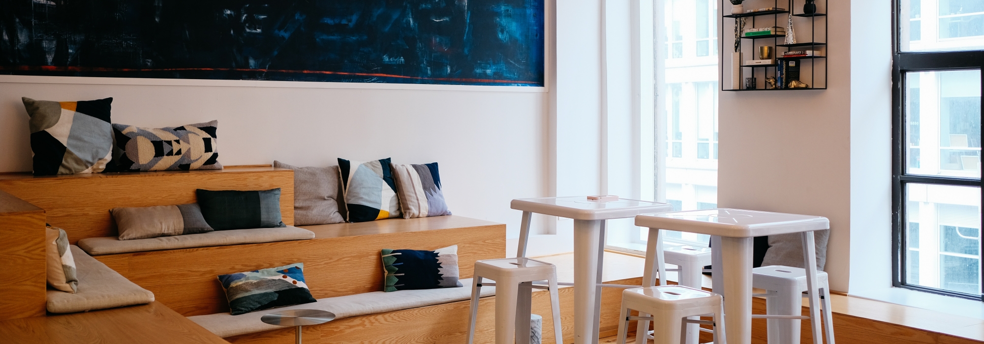 A coworking space showing tables and bench seating.